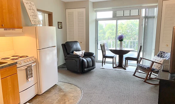 Plymouth Place independent living apartment kitchen and living room