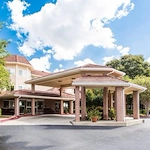 Independent living, assisted living, memory care, and continuing care retirement community (CCRC) at Brook Ridge-The Gardens Retirement Community in Pharr, TX, front exterior and entrance