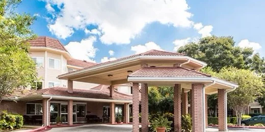 Independent living, assisted living, memory care, and continuing care retirement community (CCRC) at Brook Ridge-The Gardens Retirement Community in Pharr, TX, front exterior and entrance