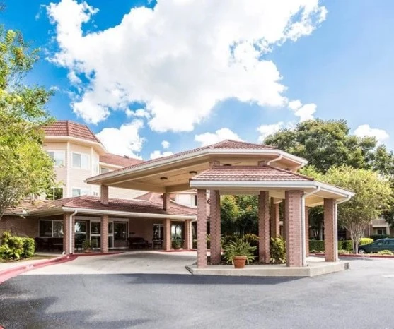 Independent living, assisted living, memory care, and continuing care retirement community (CCRC) at Brook Ridge-The Gardens Retirement Community in Pharr, TX, front exterior and entrance