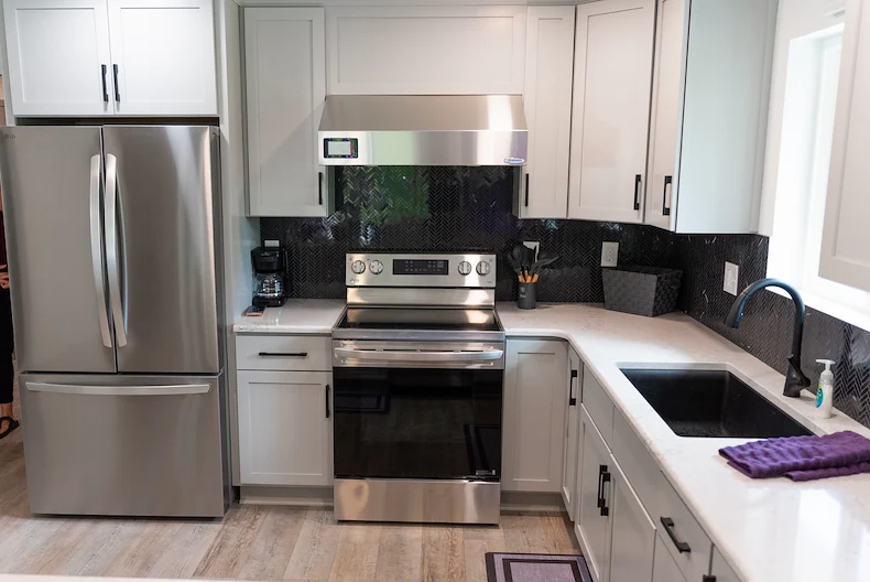 Legato Living Residential Memory Care at Heartland Hills senior living community offering assisted living, memory care, adult day services, and respite care in Bellevue, NE, kitchen with white cabinets, white countertops, and stainless steel appliances