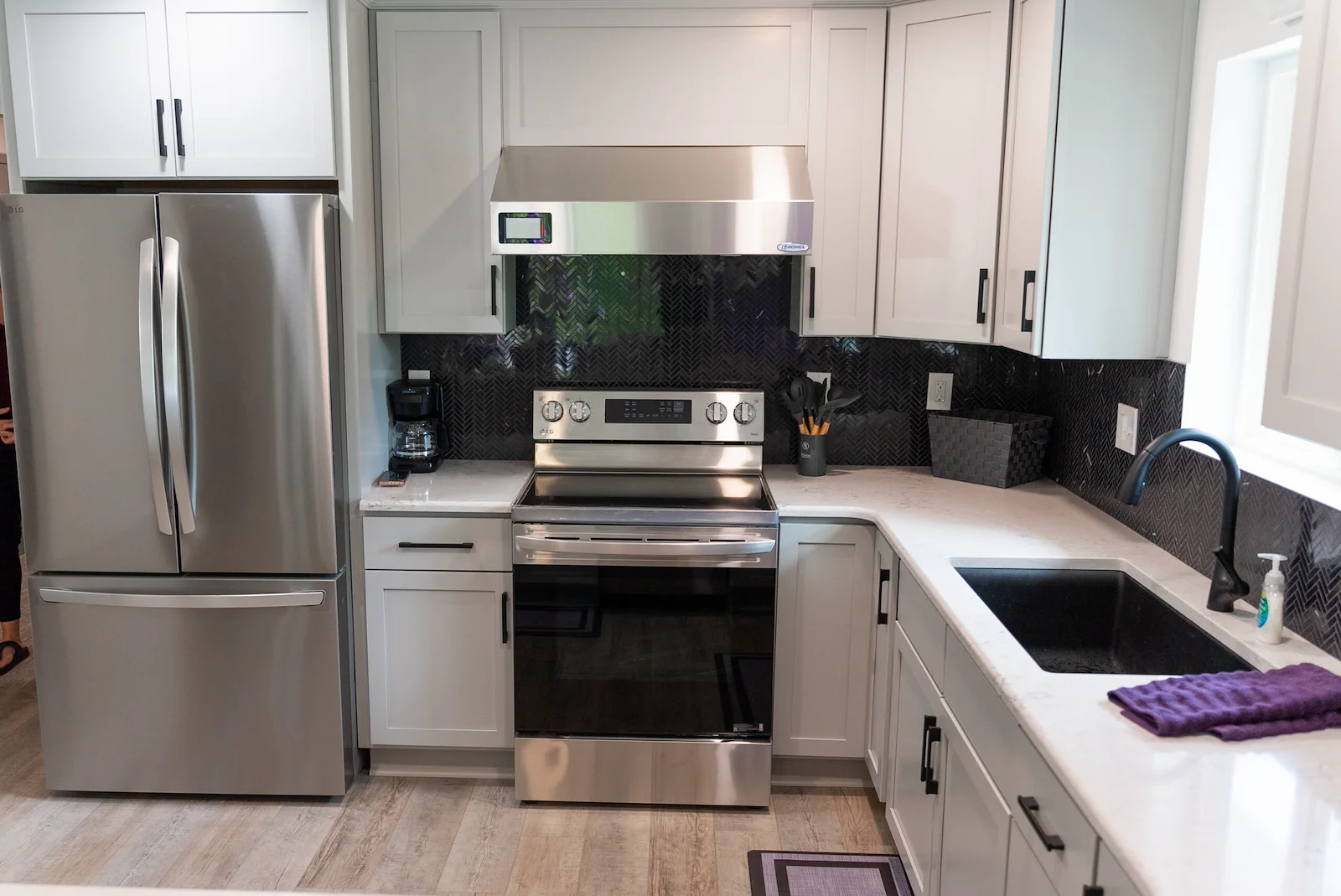 Legato Living Residential Memory Care at Heartland Hills senior living community offering assisted living, memory care, adult day services, and respite care in Bellevue, NE, kitchen with white cabinets, white countertops, and stainless steel appliances