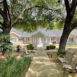 Charter Senior Living of Gainesville, Florida, outdoor area with seating and a walking path