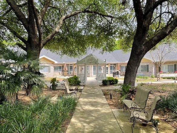 Charter Senior Living of Gainesville, Florida, outdoor area with seating and a walking path