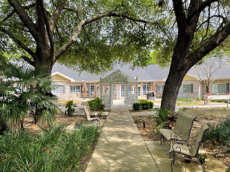 Charter Senior Living of Gainesville, Florida, outdoor area with seating and a walking path