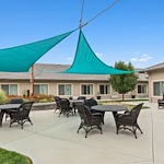 Assisted living and memory care at Belleview Heights Senior Living in Aurora, CO, outdoor space with shaded seating area