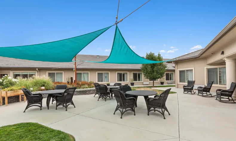 Assisted living and memory care at Belleview Heights Senior Living in Aurora, CO, outdoor space with shaded seating area