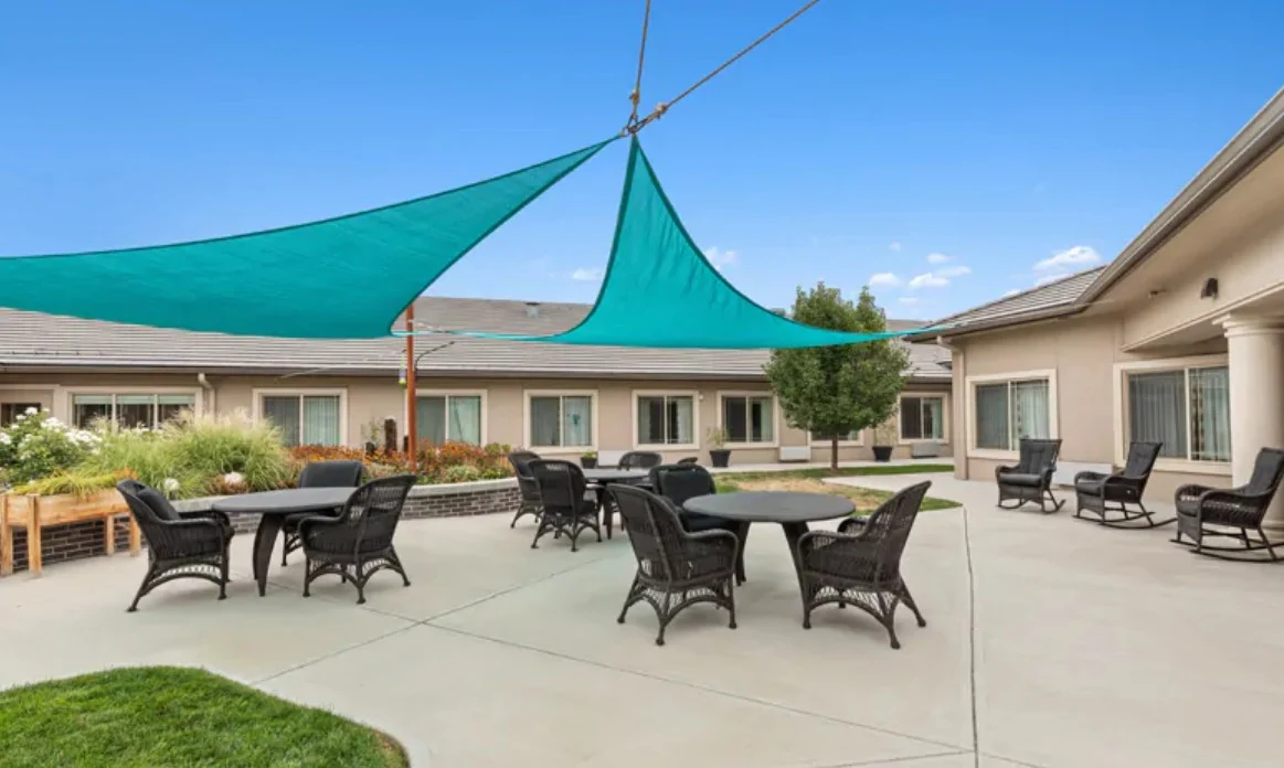 Assisted living and memory care at Belleview Heights Senior Living in Aurora, CO, outdoor space with shaded seating area
