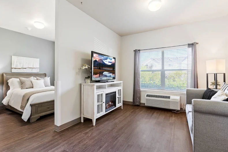 Avamere at Mountain Ridge senior living community offering assisted living, memory care, and respite care in South Ogden, UT, apartment featuring a living room and bedroom
