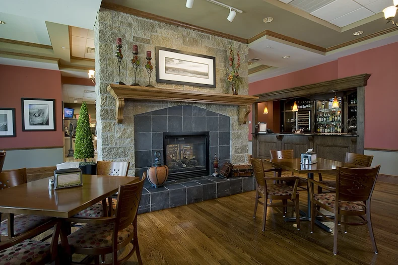 Covenant Living at Inverness in Tulsa, OK, visiting area by fireplace