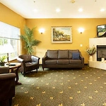 Albany Senior Living by Cogir, assisted living and respite care community in Albany, OR, common sitting area by fireplace
