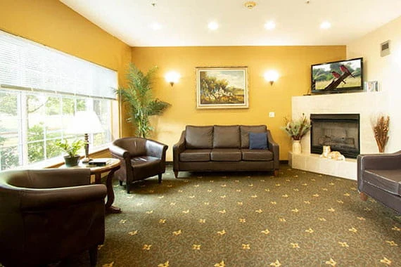 Albany Senior Living by Cogir, assisted living and respite care community in Albany, OR, common sitting area by fireplace
