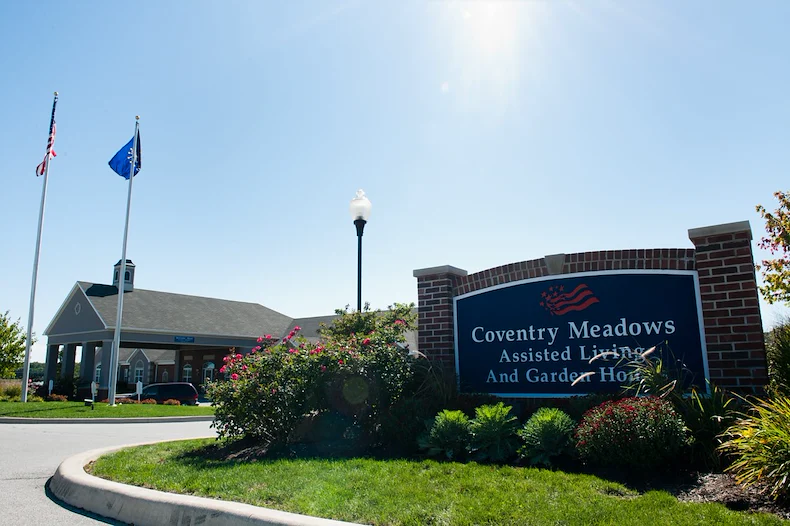 Coventry Meadows Senior Living in Fort Wayne, IN front exterior entrance sign that reads "Coventry Meadows Assisted Living And Garden Homes"