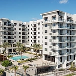 Allegro Fort Lauderdale, senior living community in Fort Lauderdale, FL, offering independent living, assisted living, memory care, and respite care, exterior featuring a community pool and balconies