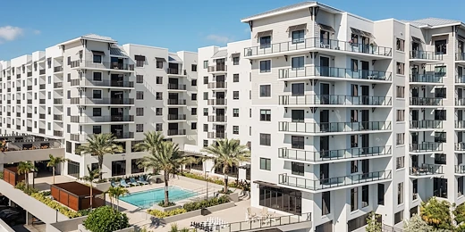 Allegro Fort Lauderdale, senior living community in Fort Lauderdale, FL, offering independent living, assisted living, memory care, and respite care, exterior featuring a community pool and balconies
