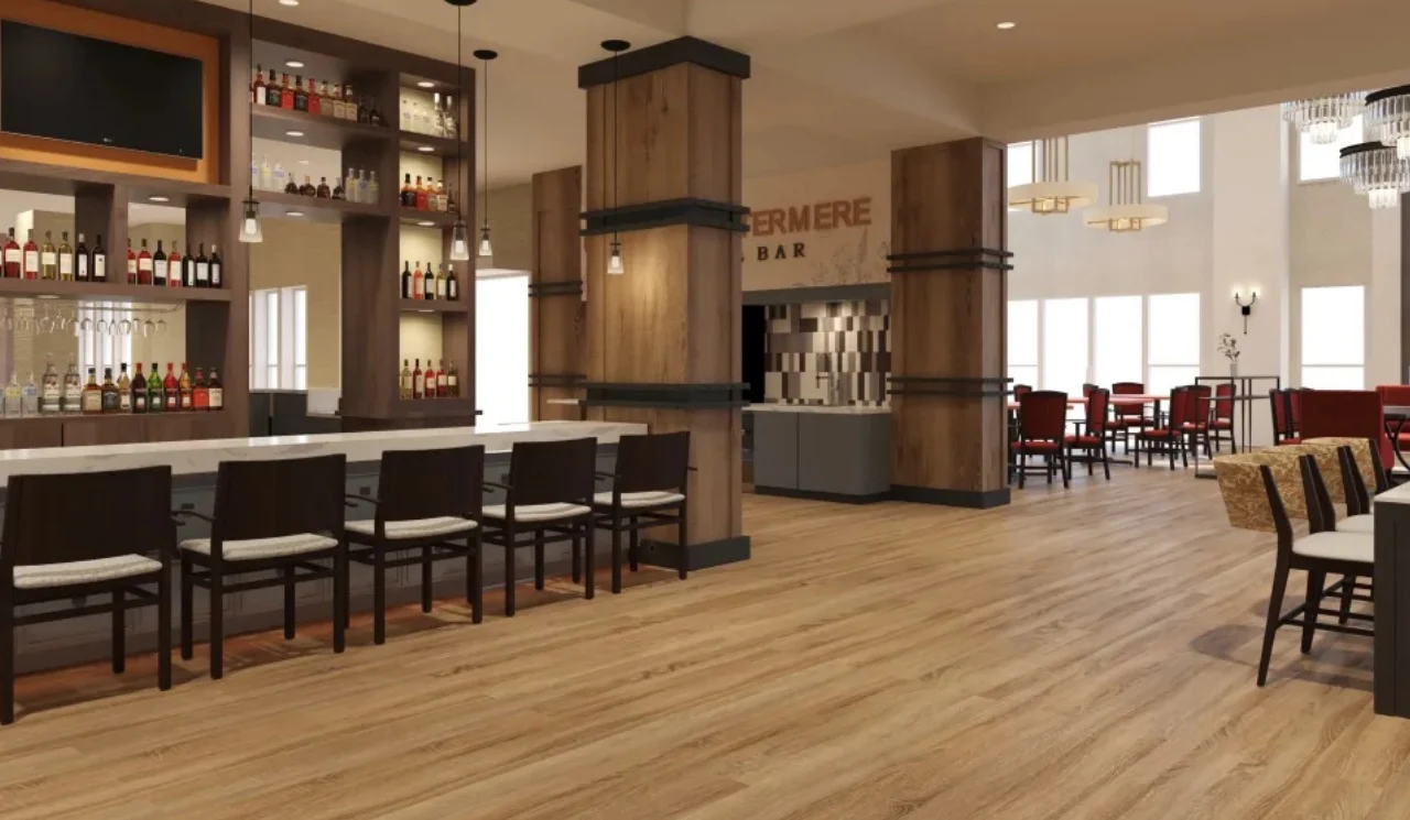 Watermere at Flower Mound senior living community offering active adult living and independent living in Flower Mound, TX, bar area with countertop and bar stool seating, with a view into the dining room