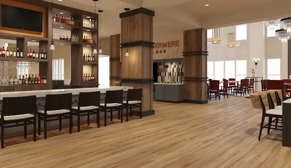 Watermere at Flower Mound senior living community offering active adult living and independent living in Flower Mound, TX, bar area with countertop and bar stool seating, with a view into the dining room