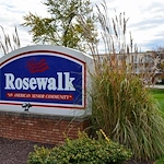 Rosewalk at Lutherwoods Assisted Senior Living in Indianapolis, IN front exterior welcome sign that says "Rosewalk 'An American Senior Community'"