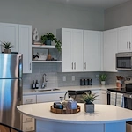 Acclaim at The Hill, senior living community offering active adult and independent living in Fredericksburg, VA, apartment kitchen with stainless steel appliances and an island