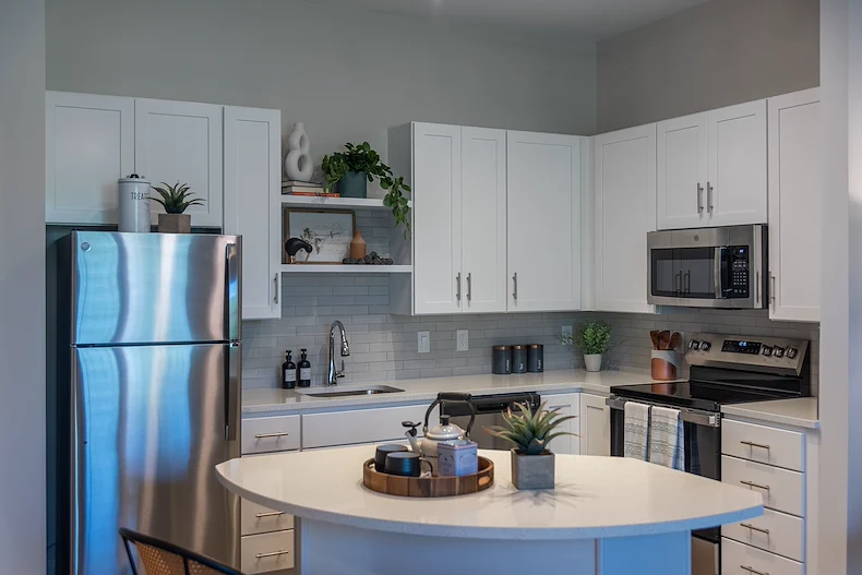 Acclaim at The Hill, senior living community offering active adult and independent living in Fredericksburg, VA, apartment kitchen with stainless steel appliances and an island