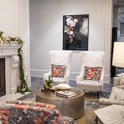 Corso Atlanta senior living community offering independent living, assisted living, memory care, and respite care in Atlanta, GA, common siting area by a fireplace