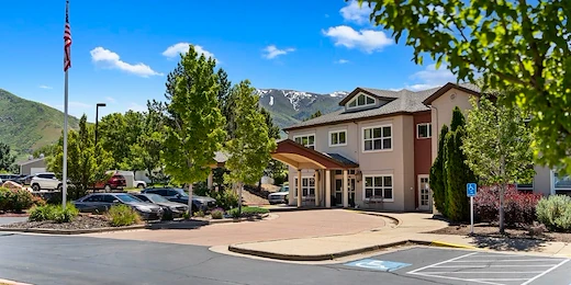 Avamere at Mountain Ridge senior living community offering assisted living, memory care, and respite care in South Ogden, UT, exterior view with mountains in the background