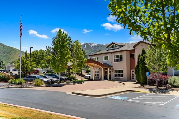 Avamere at Mountain Ridge senior living community offering assisted living, memory care, and respite care in South Ogden, UT, exterior view with mountains in the background