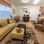 Ashton Gardens Gracious Retirement Living Hawthorn Senior Living Community in Portland, Maine apartment living room and kitchenette