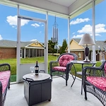 Bright sunroom with surrounding windows and comfortable seating at Charter Senior Living of Hermitage in Hermitage, TN, providing a relaxing space for residents in independent living, assisted living, and memory care.