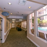 Lexington Assisted Living senior living community offering independent living, assisted living, and memory care in Ventura, CA, hallway with business office on the left and a small sitting area