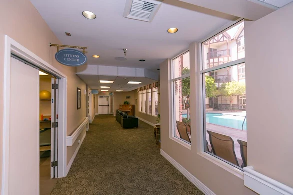 Lexington Assisted Living senior living community offering independent living, assisted living, and memory care in Ventura, CA, hallway with business office on the left and a small sitting area