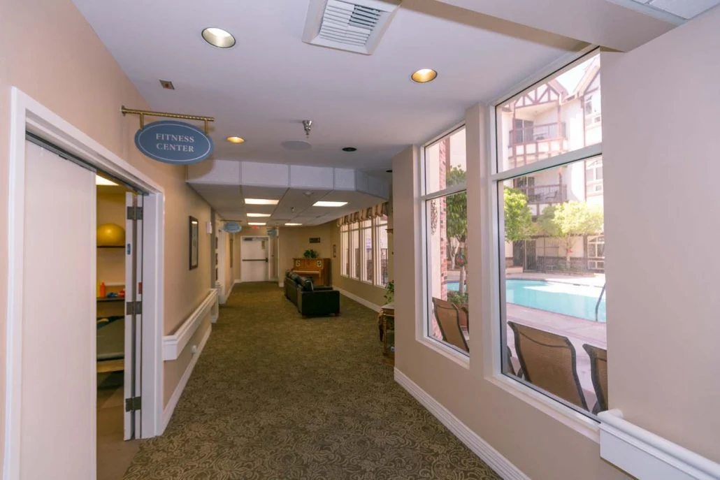 Lexington Assisted Living senior living community offering independent living, assisted living, and memory care in Ventura, CA, hallway with business office on the left and a small sitting area