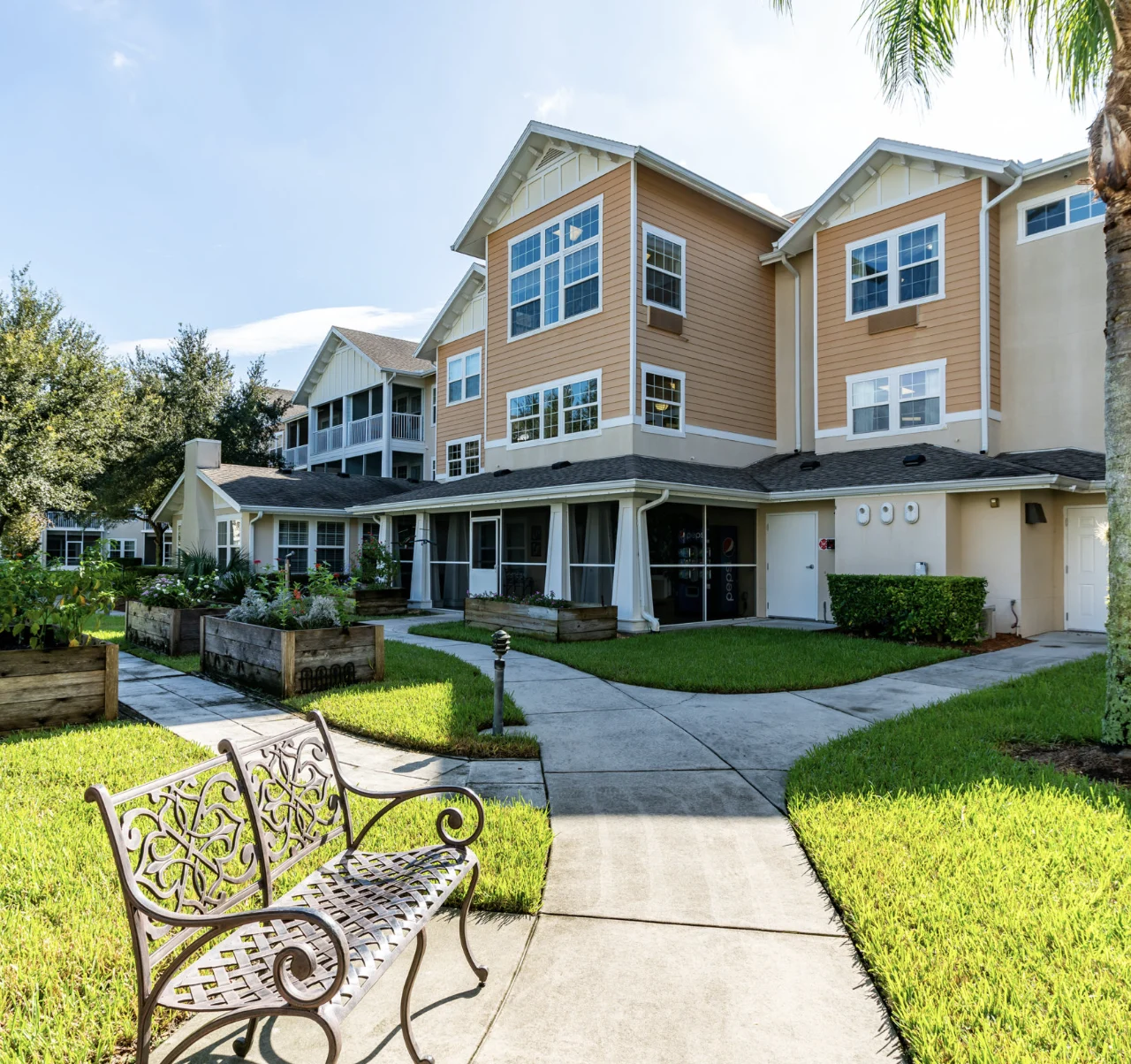 Salishan Gracious Retirement Living Hawthorn Senior Independent Living in Spring Hill, Florida rear exterior bench and garden