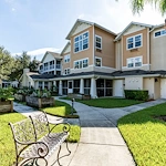 Salishan Gracious Retirement Living Hawthorn Senior Independent Living in Spring Hill, Florida rear exterior bench and garden