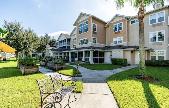 Salishan Gracious Retirement Living Hawthorn Senior Independent Living in Spring Hill, Florida rear exterior bench and garden