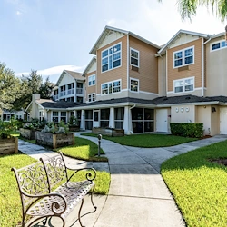 Salishan Gracious Retirement Living Hawthorn Senior Independent Living in Spring Hill, Florida rear exterior bench and garden