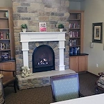 Avamere at Moses Lake senior living community offering independent living, assisted living, and respite care in Moses Lake, WA, lounge area with a fireplace and built-in bookshelves