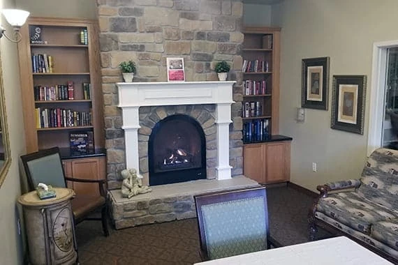 Avamere at Moses Lake senior living community offering independent living, assisted living, and respite care in Moses Lake, WA, lounge area with a fireplace and built-in bookshelves