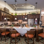 Barclay House of Aiken, senior living community offering assisted living and memory care in Aiken, SC, community kitchen with bartop seating and modern appliances