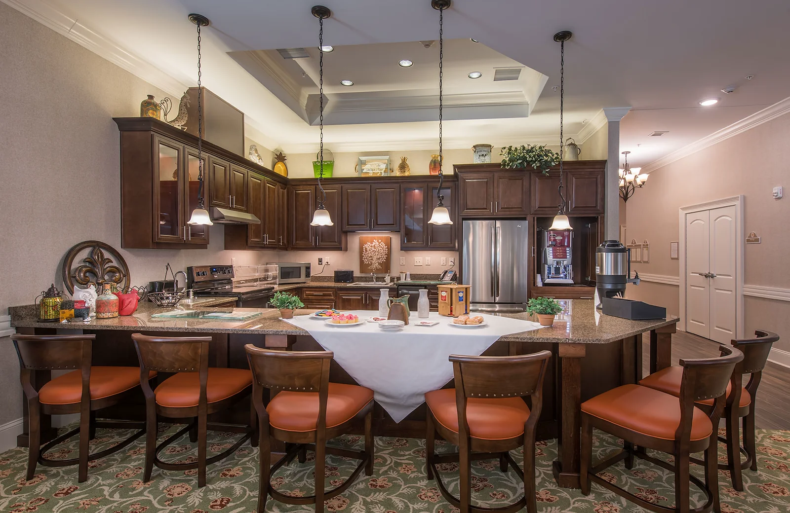 Barclay House of Aiken, senior living community offering assisted living and memory care in Aiken, SC, community kitchen with bartop seating and modern appliances