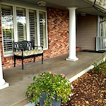 Legato Living Residential Memory Care at Legacy senior living community offering assisted living, memory care, adult day services, and respite care in Omaha, NE, front patio with a bench
