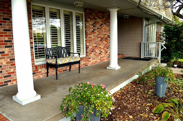 Legato Living Residential Memory Care at Legacy senior living community offering assisted living, memory care, adult day services, and respite care in Omaha, NE, front patio with a bench
