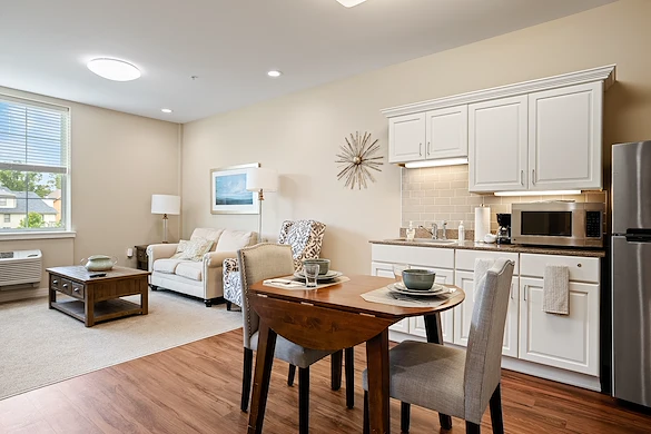 Alto Overland Park, senior living community offering assisted living and memory care in Overland Park, KS, apartment featuring a kitchenette, dining table, and comfortable living space
