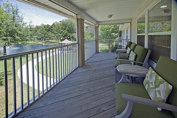 Allegro Fleming Island, senior living community offering independent living, assisted living, memory care, and respite care in Fleming Island, FL, covered deck with seating and a great view