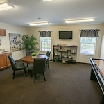 Willoughby Hills Senior Apartments community offering active adult living and independent living in Willoughby Hills, OH, multipurpose room with a kitchenette, dining table, and game table