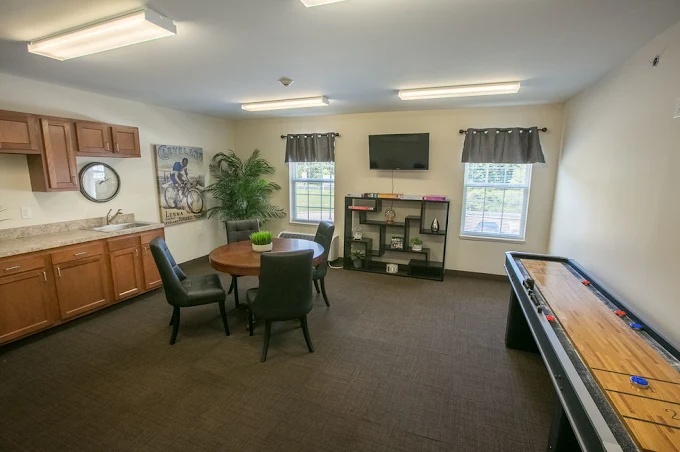 Willoughby Hills Senior Apartments community offering active adult living and independent living in Willoughby Hills, OH, multipurpose room with a kitchenette, dining table, and game table