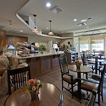 Alto Tavares, senior living community offering assisted living, memory care, and respite care in Tavares, FL, dining room with a bar area featuring snacks and drinks