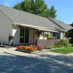 Zionsville Meadows Assisted Living, senior living community offering independent living and assisted living in Zionsville, IN, rear exterior with beautiful flowers