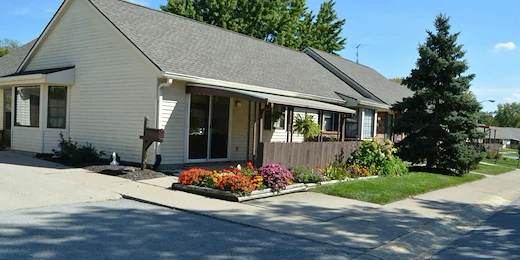 Zionsville Meadows Assisted Living, senior living community offering independent living and assisted living in Zionsville, IN, rear exterior with beautiful flowers