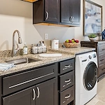 Westhill Newnan Crossing senior living community offering assisted living and memory care in Newnan, GA, apartment kitchen and laundry